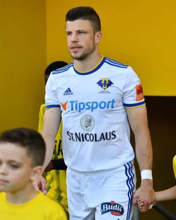 Matúš Marcin nastupuje na ihrisko spolu s mladými futbalistami.